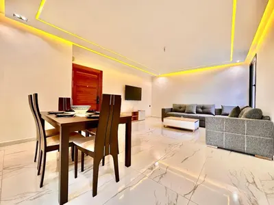 a living room with a table and a couch at Quiet & Cosy Apartment in Central Gueliz in Marrakech