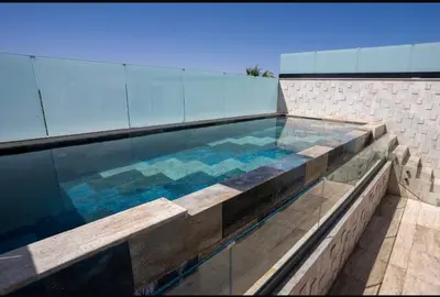 a swimming pool on the side of a building at Triplex De Luxe Ocra piscine privée in Marrakech