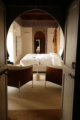 a bedroom with a bed and two chairs at Riad Djannaat Exceptional private riad pool staff in Marrakech