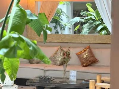 a couch in a living room with plants at Riad Aguaviva in Marrakech