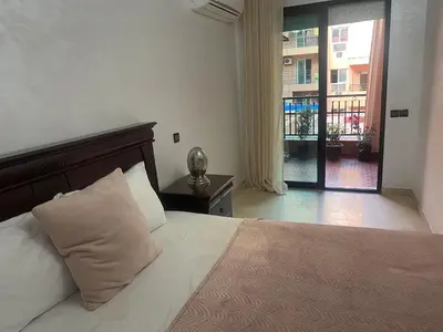 a bedroom with a bed and a view of a building at Appartement en plein centre in Marrakech
