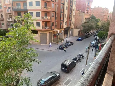 a city street with cars parked on the street at Appartement en plein centre in Marrakech