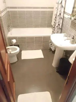 a bathroom with a tub and a sink and a toilet at Appartement en plein centre in Marrakech
