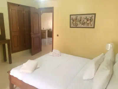 a bedroom with a white bed with two towels on it at Appartement en plein centre in Marrakech