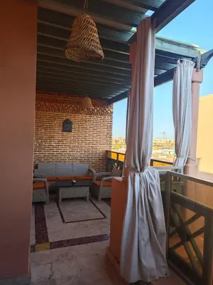 a view of a patio with a couch and a window at Ennaim in Marrakech