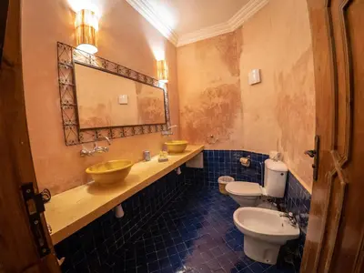 a bathroom with two sinks and two toilets at Riad Tecla in Marrakech