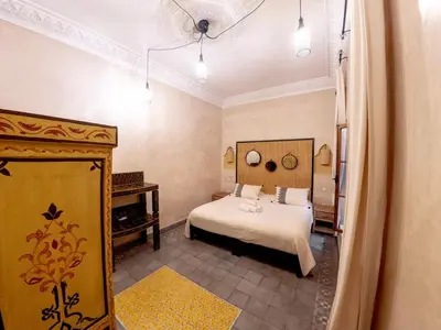 a bedroom with a bed and a piano at Riad Tecla in Marrakech