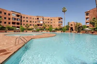 a large swimming pool in front of a building at My Palm House Marrakech avec piscine privée in Marrakech