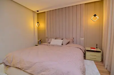 a bedroom with a large bed and a table at Luxury apartment with jaccuzi in Marrakech