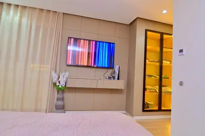 a bedroom with a television on the wall at Luxury apartment with jaccuzi in Marrakech