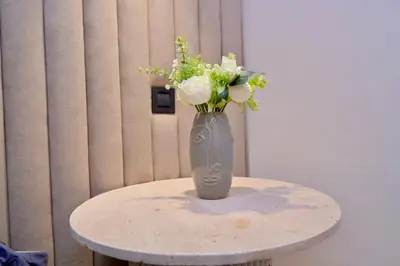 a vase with white flowers sitting on a table at Luxury apartment with jaccuzi in Marrakech