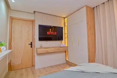 a bedroom with a bed and a tv on a wall at Luxury apartment with jaccuzi in Marrakech