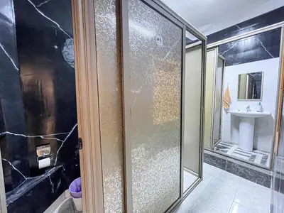 a bathroom with a shower and a sink at Bubbly Hostel Marrakech in Marrakech