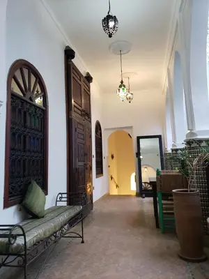 a hallway with a door and a bench in a room at Riad Alma Mouassine in Marrakech