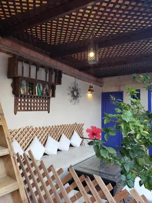 a patio with a wooden table with pillows on it at Riad Alma Mouassine in Marrakech