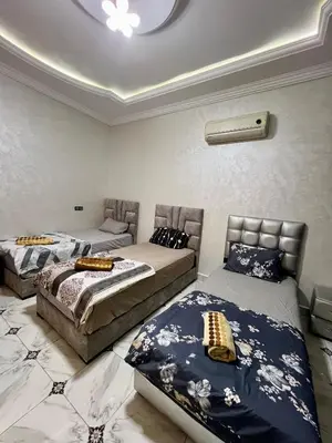 a bedroom with two beds and a ceiling at Appartement spacieux marocain traditionnel familial in Marrakech