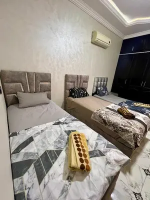 two beds sitting next to each other in a room at Appartement spacieux marocain traditionnel familial in Marrakech