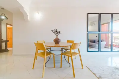 a dining room with a table and chairs at Appartement Malika Gueliz in Marrakech