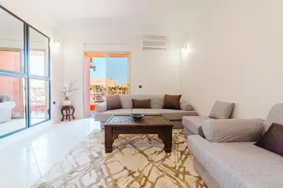 a living room with a couch and a table at Appartement Malika Gueliz in Marrakech