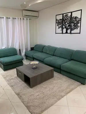 a living room with a green couch and a coffee table at welcom to Marrakech in Marrakech