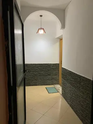 an empty hallway with a door and a tile floor at welcom to Marrakech in Marrakech