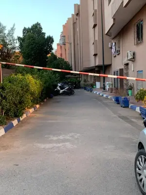 a parking lot with a red and white tape at welcom to Marrakech in Marrakech