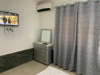 a room with a dresser with a mirror and a television at welcom to Marrakech in Marrakech