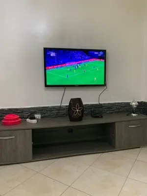 a flat screen tv on a wall in a living room at welcom to Marrakech in Marrakech