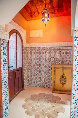 a room with a door and a wall with tiles at Charming Private Riad in Marrakech
