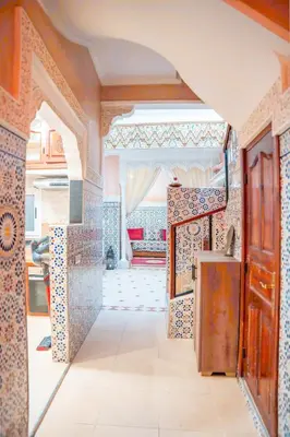 a kitchen with an archway with tiles on the walls at Charming Private Riad in Marrakech
