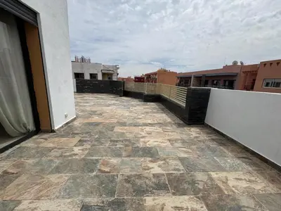 a balcony of a building with a tile floor at Splendide dernier étage plein coeur de Guéliz et Carré Eden in Marrakech