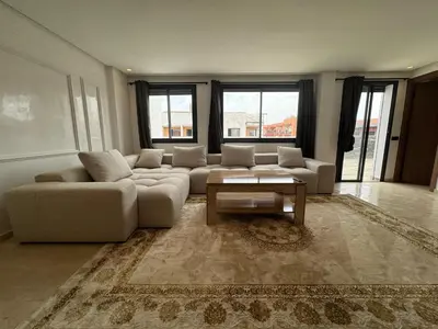 a living room with a couch and a coffee table at Splendide dernier étage plein coeur de Guéliz et Carré Eden in Marrakech