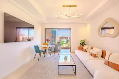 a living room with a couch and a table at New! Appt moderne avec terrasse et vue piscine in Marrakech