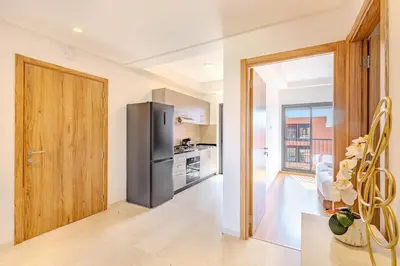 a kitchen with a stainless steel refrigerator in a room at New! Appt moderne avec terrasse et vue piscine in Marrakech