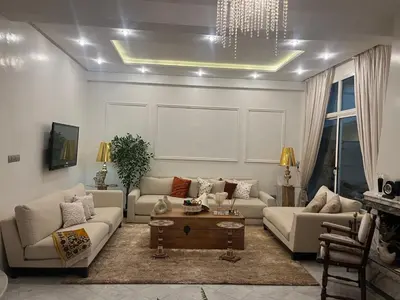 a living room with couches and a coffee table at Maison d'hôte Darkom Kech in Marrakech
