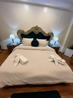 a bedroom with a large bed with two towels on it at Maison d'hôte Darkom Kech in Marrakech