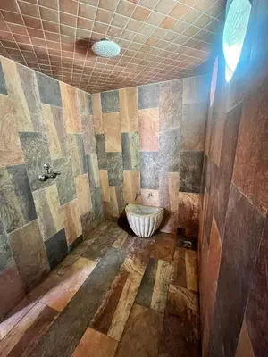 a bathroom with a tub in the middle of a room at Maison d'hôte Darkom Kech in Marrakech