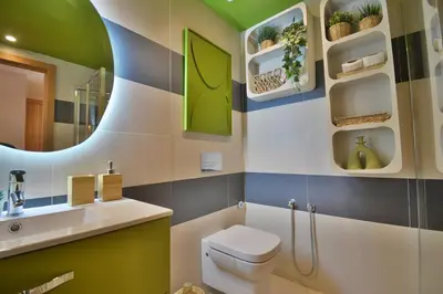 a bathroom with a toilet and a sink and a mirror at Central Luxury Quiet Hivernage 2 Balconies With View in Marrakech