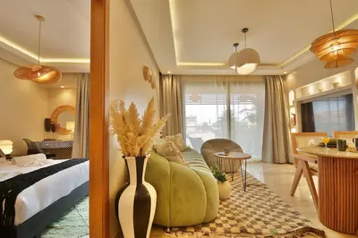 a bedroom with a bed and a vase with flowers in it at Central Luxury Quiet Hivernage 2 Balconies With View in Marrakech