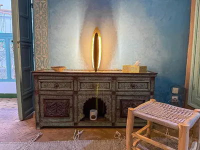 an old wooden dresser with a fireplace in a room at Riad medina d'or in Marrakech