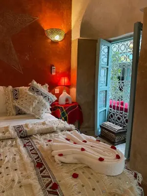 a bedroom with two beds with pillows and a window at Riad medina d'or in Marrakech