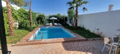 a swimming pool in a backyard with palm trees at VILLa PALMS KECH in Marrakech