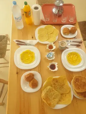 a table with plates of breakfast food on it at VILLa PALMS KECH in Marrakech