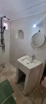 a bathroom with a sink and a mirror on the wall at VILLa PALMS KECH in Marrakech
