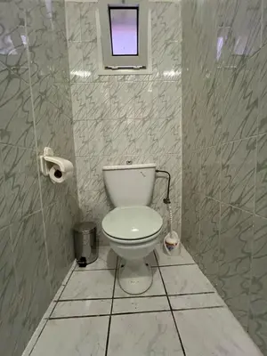 a bathroom with a white toilet and a window at Riad Al Hanaa in Marrakech