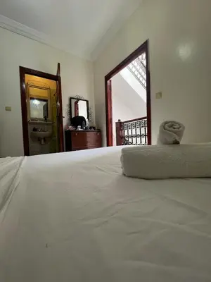 a bedroom with a large white bed and a window at Riad Al Hanaa in Marrakech