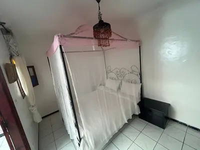 a white shower with a pink canopy in a room at Riad Al Hanaa in Marrakech