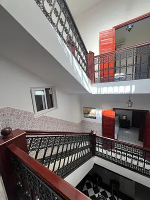 a staircase in a building with a balcony at Riad Al Hanaa in Marrakech