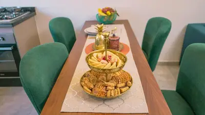 a table with a plate of food on it at Appartement chaleureux agréable pour des vacances en famille in Marrakech
