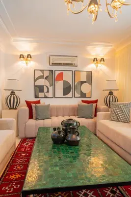 a living room with a couch and a table at Un magnifique appartement avec jardin à Marrakech in Marrakech